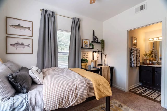 Bed with desk and view of adjoining bathroom bedroom at The Ranch Student Apartments in San Marcos Student Accommodation