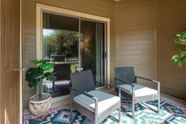 Two chairs plant on colorful rug exterior at The Ranch Student Apartments in San Marcos Student Accommodation