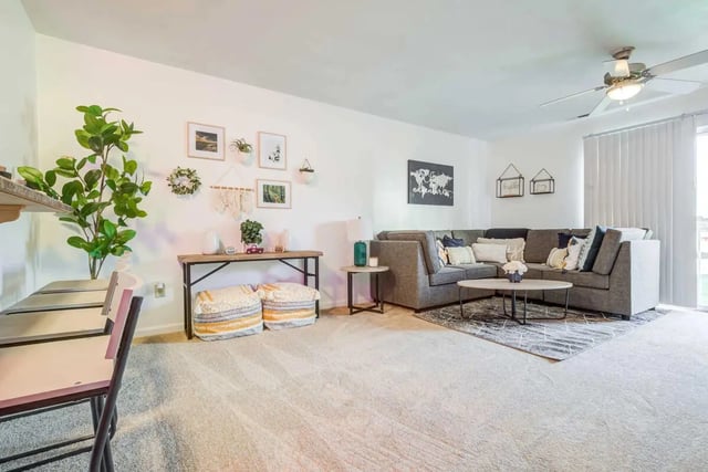 Gray sectional sofa with pillows living room at Maple Ridge Townhomes in Blacksburg Student Accommodation