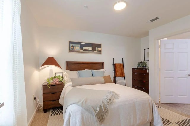 Bed nightstand dresser ladder and painting bedroom at The View Apartments in State College Student Accommodation