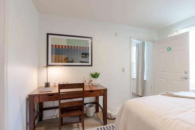 Desk chair lamp and framed art study area bedroom at The View Apartments in State College Student Accommodation
