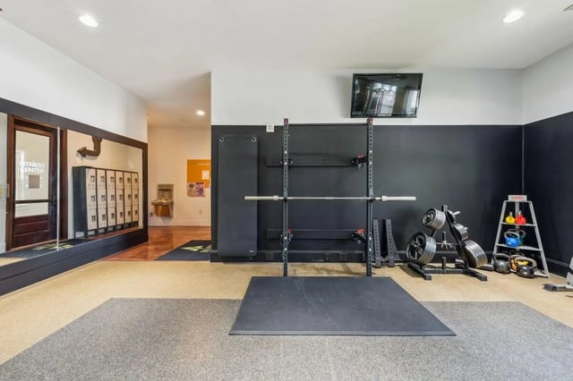 Weight rack lockers and TV gym at The View Apartments in State College Student Accommodation