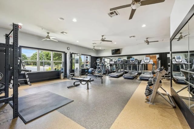 Treadmills weight racks barbells gym equipment playing area at The View Apartments in State College Student Accommodation