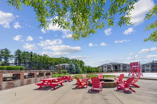 Picnic tables and chairs around fire pit exterior at The View Apartments in State College Student Accommodation