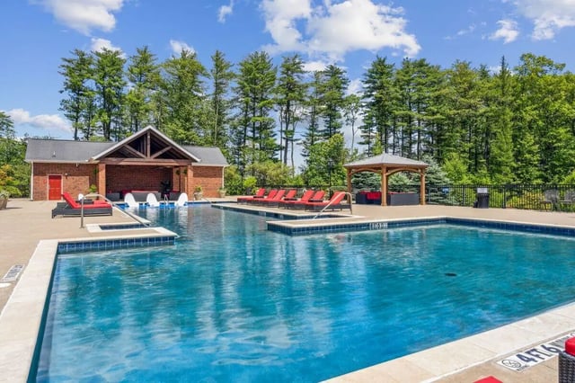 Pool with lounge chairs and cabana exterior at The View Apartments in State College Student Accommodation