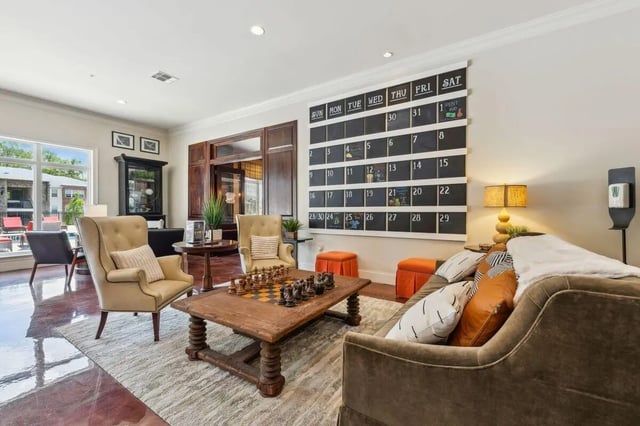 Chessboard coffee table two armchairs calendar living room at The View Apartments in State College Student Accommodation