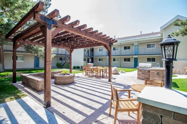 Pergola fire pit dining table grilling station exterior at Alpine Chalet in Rexburg Student Accommodation