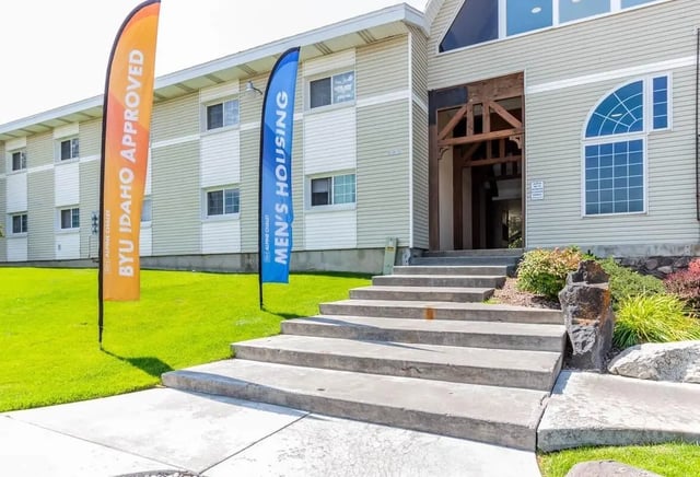 Flags stairs entrance building exterior at Alpine Chalet in Rexburg Student Accommodation