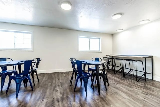 Tables chairs and bar with stools common area at Alpine Chalet in Rexburg Student Accommodation