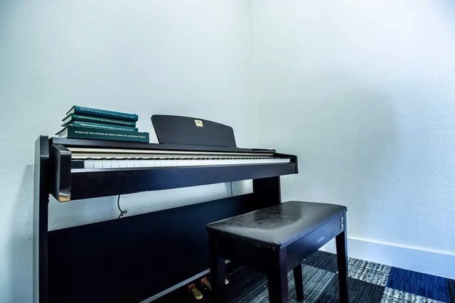 Piano with bench and books Music room at Alpine Chalet in Rexburg Student Accommodation