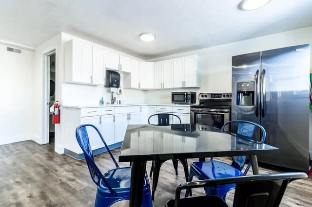 Kitchen with stainless steel appliances and dining table at Alpine Chalet in Rexburg Student Accommodation