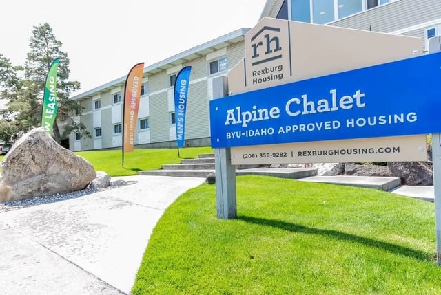 Sign with Alpine Chalet text and building exterior at Alpine Chalet in Rexburg Student Accommodation