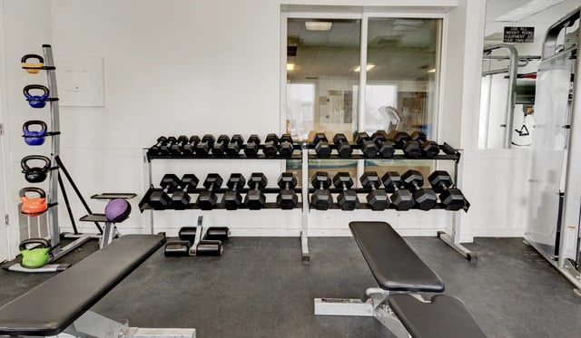 Dumbbells kettlebells weights bench gym room at Alpine Chalet in Rexburg Student Accommodation