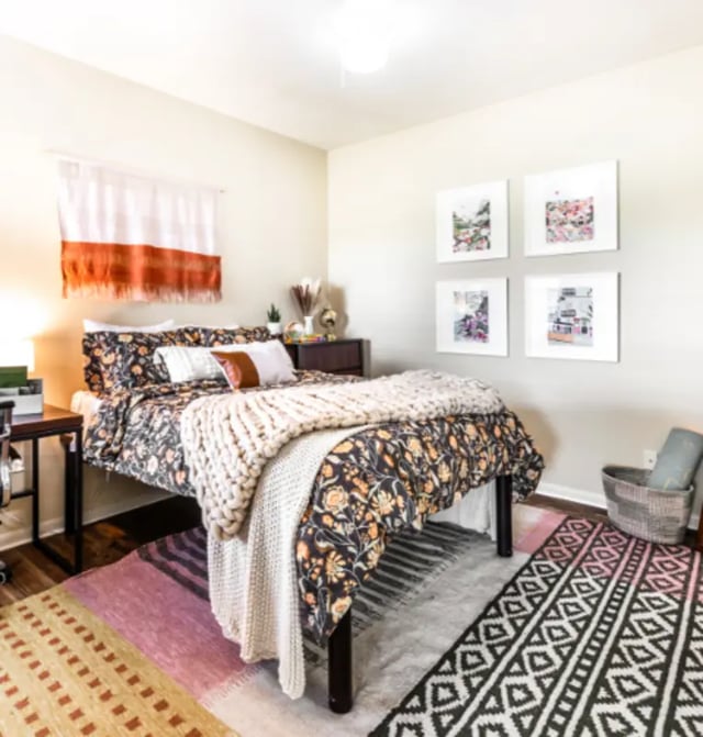Bed with patterned bedding and chunky knit throw bedroom at The Cottages at Hillside Ranch in San Marcos Student Accommodation