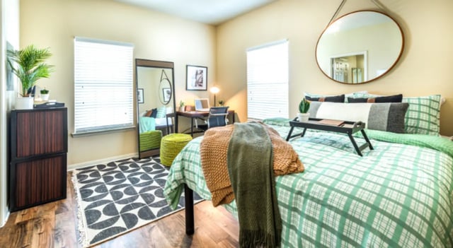 Bed desk mirror rugs and throws bedroom at The Cottages at Hillside Ranch in San Marcos Student Accommodation