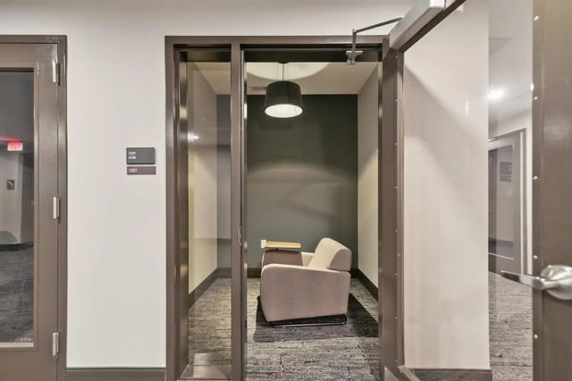 Armchair table lamp dark wall study room at The Main on University in Fairfax Student Accommodation