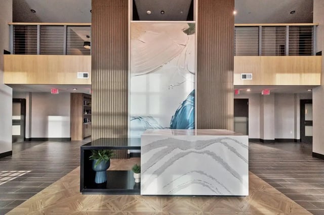 Modern reception desk artwork plants entryway lobby at The Main on University in Fairfax Student Accommodation