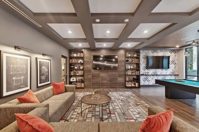 Lounge with sofas coffee table pool table living room at The Main on University in Fairfax Student Accommodation