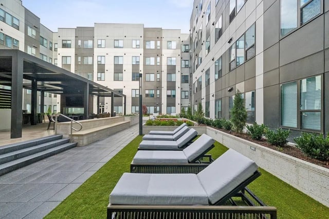 Loungers and patio area exterior at The Main on University in Fairfax Student Accommodation