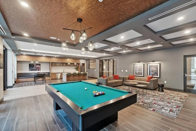 Pool table foosball table couches bar lounge area at The Main on University in Fairfax Student Accommodation