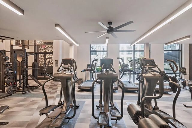 Ellipticals treadmills weight rack gym equipment fitness area at The Main on University in Fairfax Student Accommodation