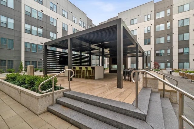 Pergola with bar seating and tables outdoor area at The Main on University in Fairfax Student Accommodation