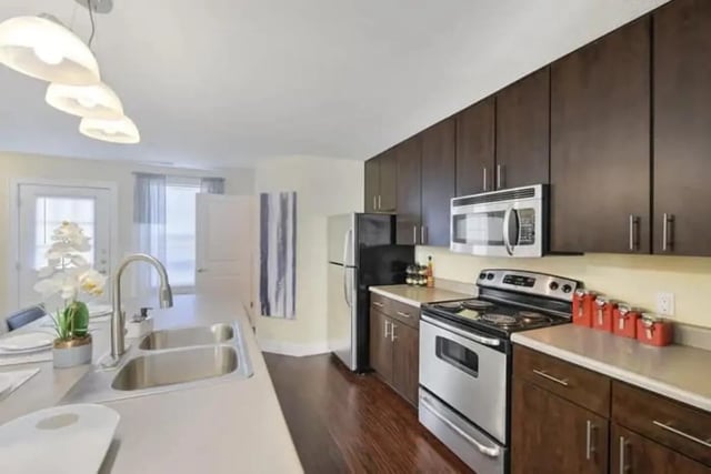 Modern kitchen with dark cabinets sink stove and appliances Kitchen at The Avenue at Orono in Orono Student Accommodation