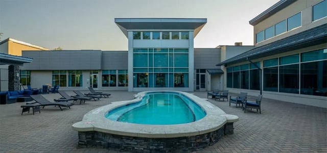 Outdoor pool lounge chairs seating area Exterior at The Avenue at Orono in Orono Student Accommodation