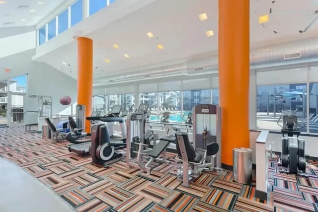 Treadmills weight machines colorful patterned carpet fitness center at The Avenue at Orono in Orono Student Accommodation