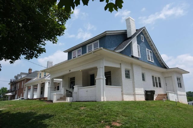 White brick house blue upper story exterior at College Corners on High in Farmville Student Accommodation
