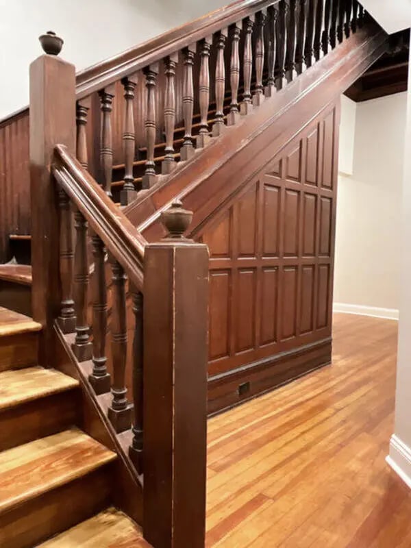 Wooden staircase with paneling and floor interior at College Corners on High in Farmville Student Accommodation