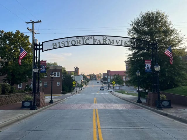 Farmville welcome arch American flags street exterior at College Corners on High in Farmville Student Accommodation
