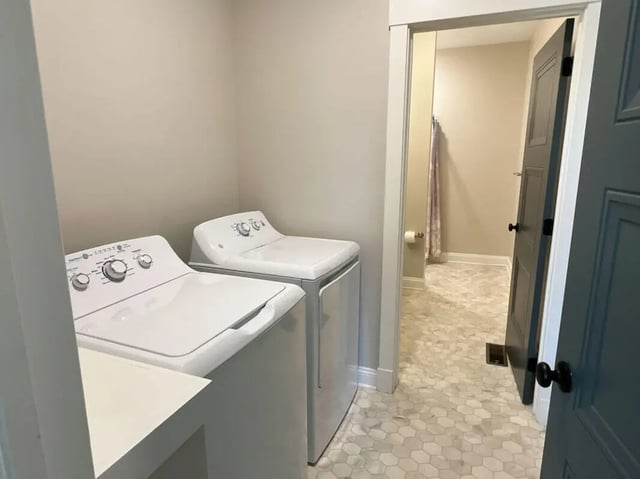 Two white washing machines leading to bathroom Laundry room at College Corners on High in Farmville Student Accommodation