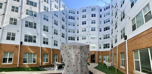 Courtyard climbing wall hammock and table exterior at 8N Lofts in Lincoln Student Accommodation