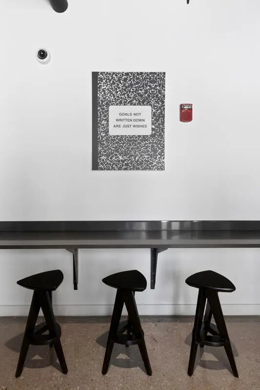 Three black stools under a metal desk study area at Atmosphere Lincoln in Lincoln Student Accommodation