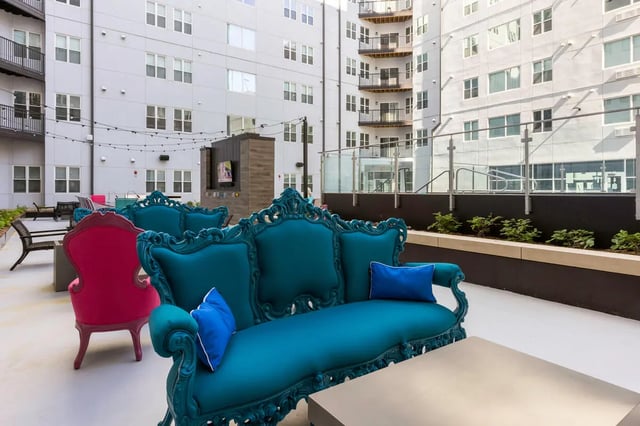 Ornate teal couch and chairs outdoor lounge area at Atmosphere Lincoln in Lincoln Student Accommodation