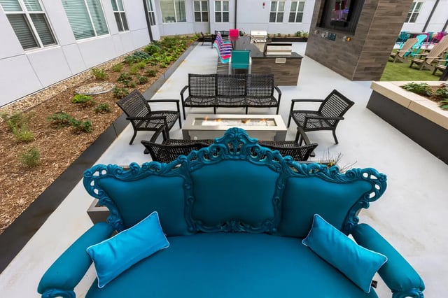 Teal ornate sofa fire pit grill seating playing area at Atmosphere Lincoln in Lincoln Student Accommodation