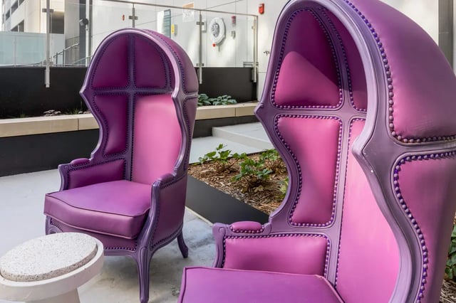 Two purple ornate chairs and a small table outdoor seating area at Atmosphere Lincoln in Lincoln Student Accommodation