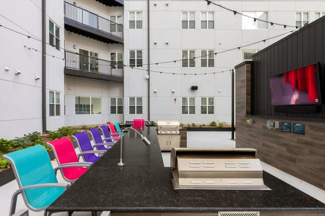 Bar with grills and colorful chairs exterior at Atmosphere Lincoln in Lincoln Student Accommodation