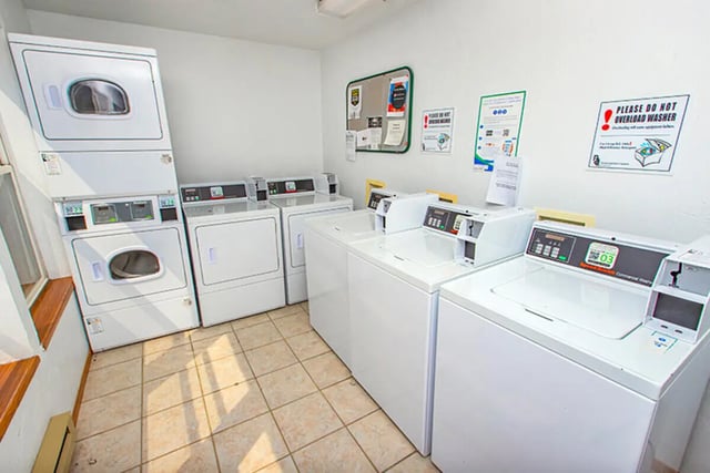 Multiple washing machines and dryers laundry area at Campus Side in Slippery Rock Student Accommodation