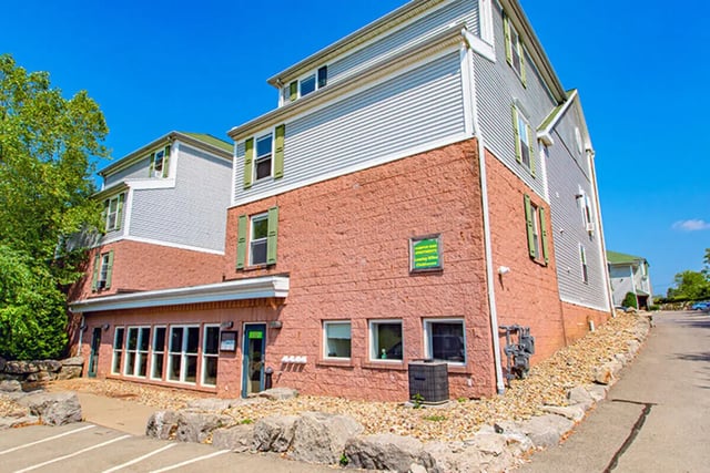 Brick building with green shutters exterior at Campus Side in Slippery Rock Student Accommodation
