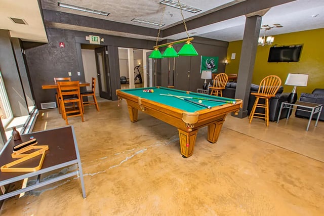 Billiard table dining table chairs lounge seating game room at Campus Side in Slippery Rock Student Accommodation