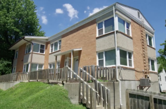 Brick building with windows and fence exterior at Denice.com in Columbia Student Accommodation
