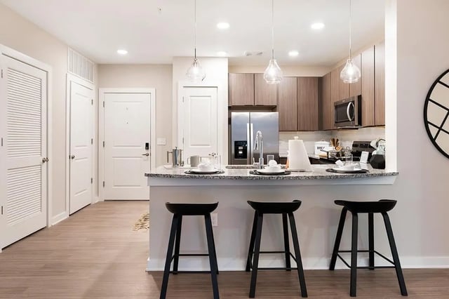 Kitchen island with stools and cabinets kitchen at The Indy in Marietta Student Accommodation