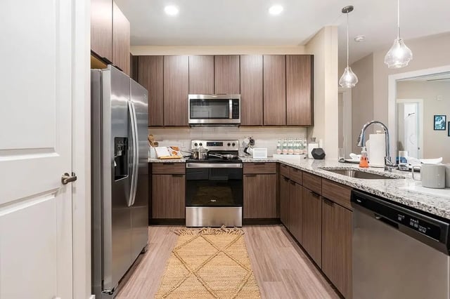 Stainless steel refrigerator microwave stove cabinets sink kitchen at The Indy in Marietta Student Accommodation