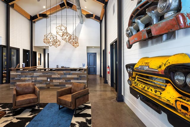Two chairs reception desk car art lobby at University Trails Apartments in Ann Arbor Student Accommodation