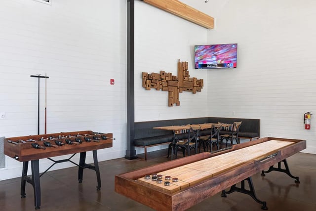 Foosball shuffleboard table and seating area living room at University Trails Apartments in Ann Arbor Student Accommodation