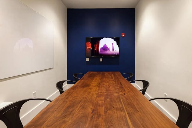 Wooden table with chairs and TV study area at University Trails Apartments in Ann Arbor Student Accommodation