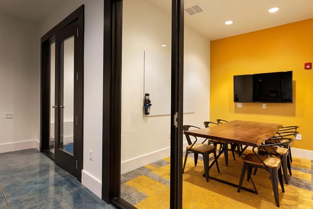 Meeting room with table chairs TV whiteboard. at University Trails Apartments in Ann Arbor Student Accommodation