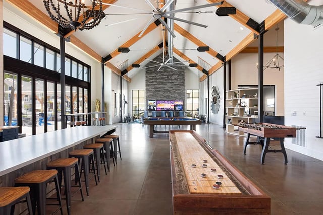 Shuffleboard foosball tables bar with stools living room at University Trails Apartments in Ann Arbor Student Accommodation